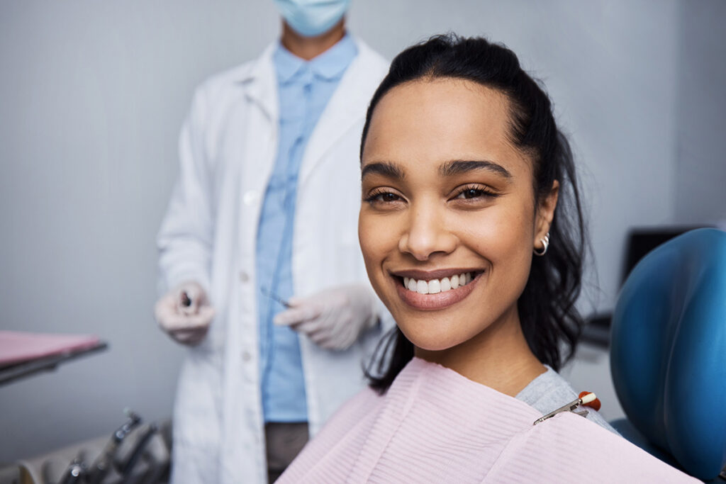 Smiling woman seated for a cosmetic dentistry appointment